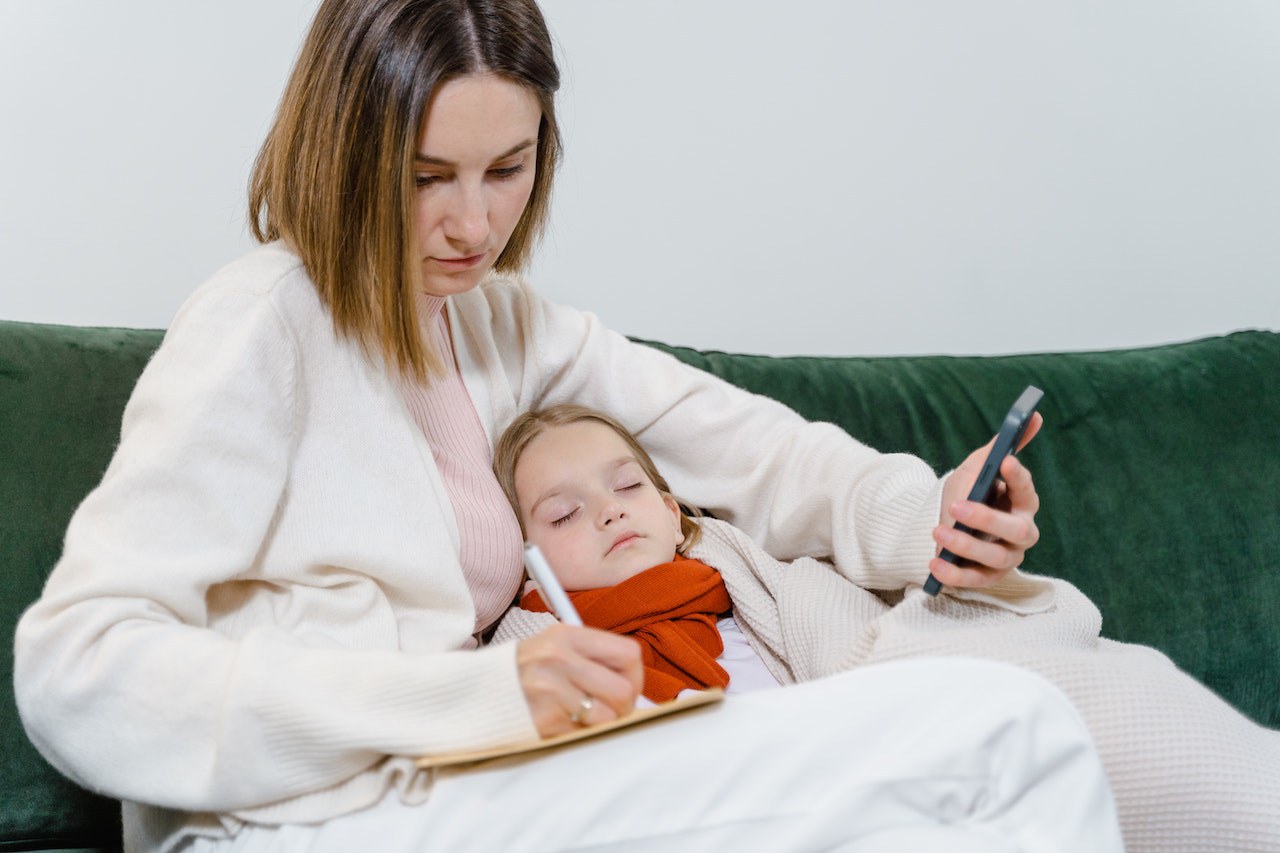 A mother taking care of her sick child